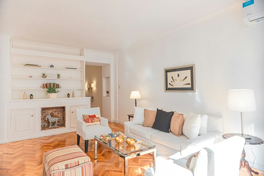 a living room filled with furniture and a fire place